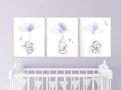 two pictures of elephants with balloons hanging on the wall above a crib in a baby's room