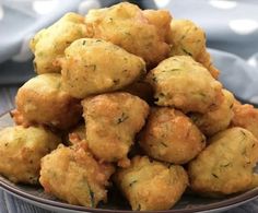 a plate filled with fried food on top of a wooden table