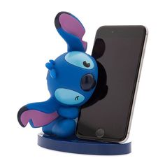 a blue phone holder with a cartoon character holding it up to the side, in front of a white background