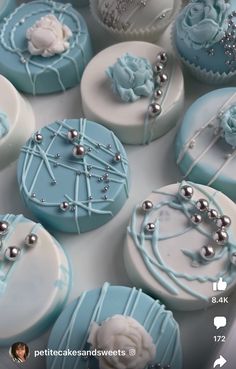 some blue and white decorated cupcakes in a box