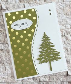 a christmas card with a pine tree on the front and gold dots on the back