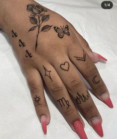 a woman's hand with tattoos on it