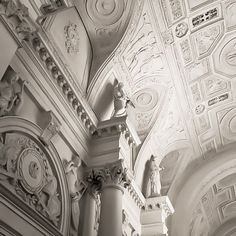 black and white photograph of an ornate ceiling in a building with decorative plaster work on the walls