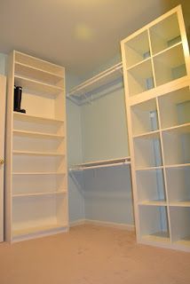 an empty room with white shelves and shelving