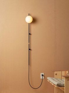 a wall mounted light next to a wooden bench