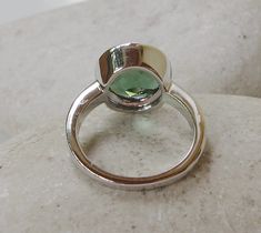 "A Classic Round shaped Forest Green Quartz Sterling Silver Ring featuring a comfort fit band with a bezel around the stone. This makes a great ring to stack with our other gemstone rings! Wrapped in a box ready for gift giving.(r-b-11) RING INFO ---------------- STERLING SILVER STONE SIZE 10MM(0.39 inches) Matching Stud Earring https://www.etsy.com/listing/227396116/sale-green-quartz-earring-green-topaz?ref=shop_home_active_19 Visit our Ring Section https://www.etsy.com/shop/Belesas?section_id= Modern Emerald Open Ring With Bezel Setting, Adjustable Emerald Ring With Bezel Setting, Topaz Ring With Bezel Setting, Topas Ring, Green Topaz, Green Stone Rings, Moonstone Engagement, Moonstone Engagement Ring, Bezel Ring