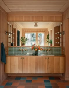 a bathroom with wooden cabinets and tiled flooring next to a window in the wall