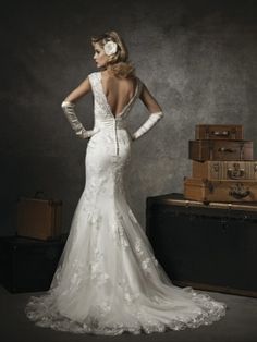 a woman in a wedding dress standing next to luggage