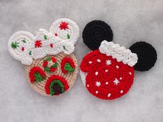 two crocheted mickey and minnie mouse heads