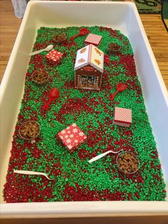 a large white tray filled with lots of green and red sprinkles on top of a table