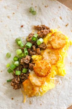 a tortilla filled with meat and veggies