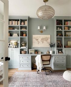 a home office with built in bookshelves and desk