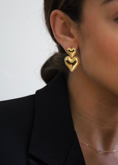 Introducing our Double Gold Heart Earrings – because one heart just wasn't enough! These earrings are like a double dose of love and flair, crafted with care to bring a touch of romance to your everyday look. 18 Karat Gold Plated on Stainless Steel Hypoallergenic, water and tarnish resistant Clasp closure Length: 3.22 cm Weight: 9.17g Chic Earrings Classy, Heart Earrings Aesthetic, Valentines Shoot, Gold Heart Earrings, Jewellery Business, Gold Heart Earring, Gold Accessories