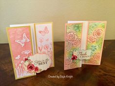 three cards with flowers and butterflies on them sitting on a table next to each other