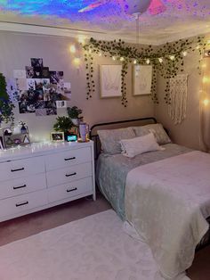 a bed room with a neatly made bed and lots of lights on the wall above it