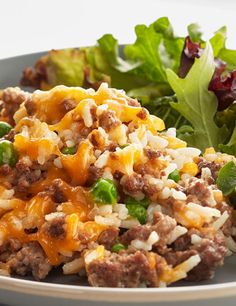 a close up of a plate of food with lettuce and cheese on it