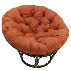 a round chair with an orange cushion on the top and bottom, sitting in front of a white background