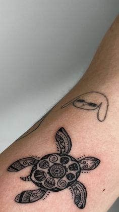 a close up of a person's arm with a tattoo design on the arm