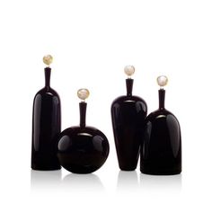 three black glass vases with gold accents