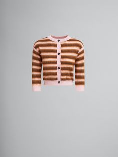 a brown and white striped sweater with buttons on the front, hanging from a hook