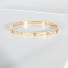 This is part of Chairish’s Fine Jewelry assortment.  Cartier Love Bracelet, Small Model, Paved 18K Yellow Gold 0.95 CTW   PRIMARY DETAILS   SKU: 137659   Listing Title: Cartier Love Bracelet, Small Model, Paved 18K Yellow Gold 0.95 CTW   Condition Description: Cartier's Love collection is the epitome of iconic, from the recognizable designs to the history behind the line-up. The collection started in 1969 with the bangle bracelet, which is engraved with a circular motif throughout to mimic the look of the bracelet's signature screw-lock mechanism.       Retails for 27300 USD. In excellent condition and recently polished. Comes with Box;Pouch;Original Receipt;   Brand: Cartier   Collection/Series: Love   Metal Type: Yellow Gold   Metal Purity: 18K   Pre-Owned Jewelry Condition: Excellent Luxury Engraved Round Bracelets, Cartier Gold Jubilee Bracelet For Wedding, Cartier Fine Jewelry Bracelet With Diamond Accents, Cartier Gold Bangle Bracelet For Wedding, Gold Cartier Diamond Bracelet With 17 Jewels, Cartier Diamond Accented Bracelets As Gift, Luxury Cartier Bracelets For Wedding, Cartier Bracelets With Diamond Accents For Gift, Luxury Bracelets With Intricate Design