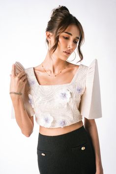 Experience timeless elegance with The Mestizo's Lumina Filipiniana Blouse from the Luxe Collection. Crafted from exquisite ivory lace fabric, this women’s blouse epitomizes modern Filipino couture with its luxurious materials and meticulous craftsmanship. Adorned with shimmering beadwork and intricate 3D flowers, each detail is a testament to our commitment to excellence. The square neckline adds sophistication while the crop length offers a contemporary twist, making it perfect for special occa Blouse Necklines Designs, Modern Filipiniana Outfit Classy Pants, Modern Filipiniana Top, Filipiniana Top, National Dress