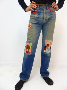 "These are a unique vintage pair of red line levi men's jeans from the 1970's.  They were customized back in the 70's and maybe even later where the bottom part of the legs is from a different jean.  These are a bit fragile and can tear and break easily.  There are some holes in the pants.  One on the rear end and some by the hip area.  Our model states that these feel like a \" 30'' waist and a 31'' length\" When we lay them down to measure across the pants we have: 15.5'' across the waist 29'' inseam 8'' opening at base of the pant leg 9'' across the thigh area I have many more photos if you are an interested buyer and would like to see more, please let me know and I will be glad to send them to you. Ships via FED EX with Insurance to the usa states" Retro Wide Leg Patchwork Jeans, Retro Red Wide Leg Jeans, Retro Fitted Patchwork Jeans, Retro Patchwork Fitted Jeans, Red Retro Denim Bottoms, Vintage Straight Leg Patchwork Bottoms, Vintage Patchwork Straight Leg Bottoms, Fitted Vintage Jeans With Patchwork, Fitted Retro Recycled Denim Bottoms