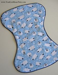 a blue bib with white sheep on it