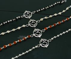 This amazing silver Rakhi crafted from 925 silver with immense precision. It exudes excellent craftsmanship and will surely look wonderful on your brother's wrist. handmade custom design Aum or OM Bracelet Or Rakhi bracelet with silver, rudraksha and holy Basil Rosary beaded chain, this is special design beaded bracelet we can use either Rakhi bracelet or daily use bracelet for unisex. Best Rakshabandhan Festival best wishes sibling gift for your brother and sister's , buyer can be select bracel Symbolic Silver Bracelets With 8mm Beads, Silver Spiritual Bracelets With Polished Beads, Polished Beads Bracelets For Festivals, Traditional White Sterling Silver Bracelets, Silver Bracelet For Puja And Festivals, Handmade Silver Beaded Bracelets For Festivals, Spiritual Sterling Silver Bracelets With Polished Beads, Spiritual Silver Hand-strung Rosary Bracelet, Silver Beads Bracelets For Puja Festivals