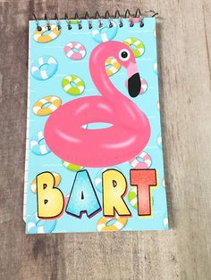 a spiral notebook with an image of a pink flamingo and the words bart on it