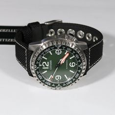 Item No. NJ2198-16X Citizen Automatic Bottle Cap Green Dial Men's Watch NJ2198-16X Watch Features: Automatic Movement Caliber 8210 40 Hour Power Reserve Stainless Steel Case Nylon Leather Strap Push Pull Crown Analog Display Green Dial Mineral Crystal Screw Back Case Buckle Clasp Case Diameter: 46 mm Case Thickness: 12 mm Water Resistance: 24mm 21 Jewels Free Priority Shipping on all orders in continental U.S. Shipping time is usually between 2 and 6 day's. 1 day handling time. About Us We are a Casual Watch Accessories With Tachymeter And Round Dial, Casual Outdoor Watch With Tachymeter, Casual Automatic Watch Accessories For Outdoor, Adjustable Watch Accessories With Analog Display For Outdoor, Adjustable Green Analog Watch, Adjustable Round Dial Watches For Outdoor, Authentic Watches, Minerals Crystals, Men's Watch