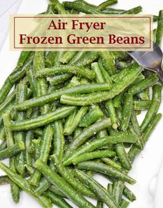 air fryer frozen green beans on a white plate with a spoon in the middle