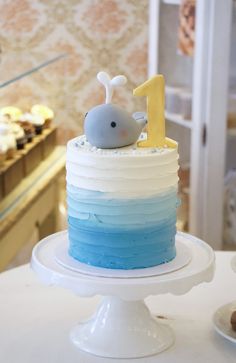 a blue and white cake sitting on top of a table