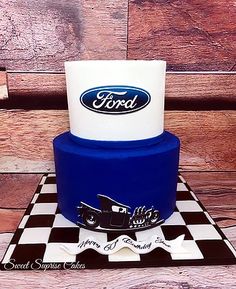 a blue and white cake sitting on top of a checkered table