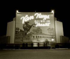 a large sign on the side of a building that says van nuys drive - in theatre