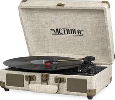 an old suitcase with a record player in it and the word victoria printed on top