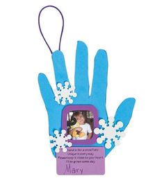 a blue hand with white flowers on it and a purple tag hanging from the wrist