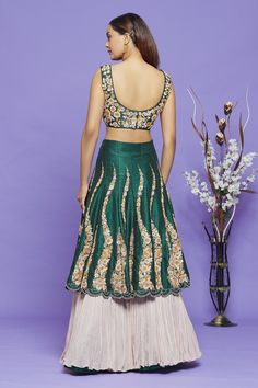 Green lehenga with thread, sequin and cutdana embroidery in a floral pattern on every kali and contrast pleated layer at the bottom. Comes with embroidered sleeveless blouse and ruffle dupatta.
Component: 3
Pattern: Embroidery
Type Of Work: Thread, Sequin and Cutdana
Neckline: Leaf
Sleeve Type: Sleeveless
Fabric: Pure Raw Silk
Color: Green
Other Details: 
Lehenga with scallop trim on the hem
Contrast pleated layer
Ruffle dupatta
Closure: Blouse: Back hook and Lehenga: Side zip
Occasion: Sangeet Sleeveless Lehenga With Floral Embroidery For Eid, Party Wear Floor-length Lehenga With Floral Embroidery, Party Wear Floral Embroidered Floor-length Lehenga, Party Wear Sets With Floral Embroidery For Reception, Floral Embroidered Party Wear Sets For Reception, Raw Silk Sharara With Floral Embroidery For Reception, Party Wear Sets In Art Silk With Intricate Embroidery, Party Wear Sets With Intricate Embroidery In Art Silk, Party Wear Semi-stitched Sharara With Floral Embroidery