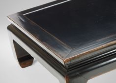 a black and silver table sitting on top of a white floor