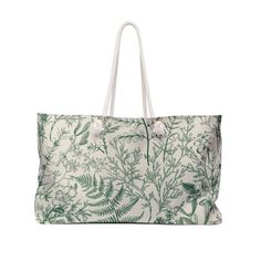 a white bag with green leaves on it