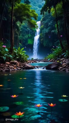 a waterfall in the middle of a forest filled with water lilies