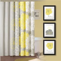 bathroom with yellow and gray shower curtain, white bath tub and pictures on the wall