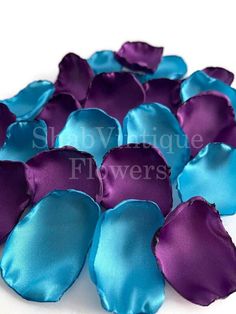 purple and teal satin flower petals on white background