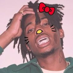 a man with dreadlocks and a hello kitty sticker on his face