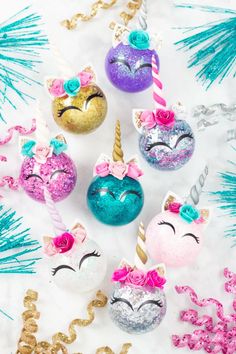 glitter unicorn ornaments are arranged on a white surface