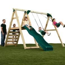 three people are standing next to a wooden swing set with two children on the swings