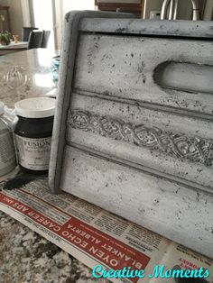 an old dresser with some paint and other items on it's counter top in a kitchen