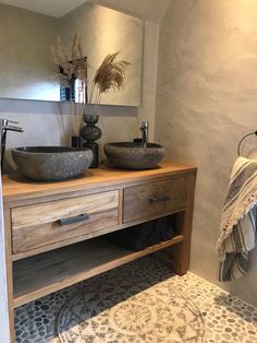 a bathroom with two sinks and a rug in front of the sink area is shown