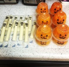 several plastic pumpkins sitting on top of a counter