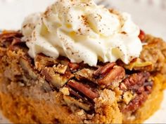 a piece of pecan pie topped with whipped cream